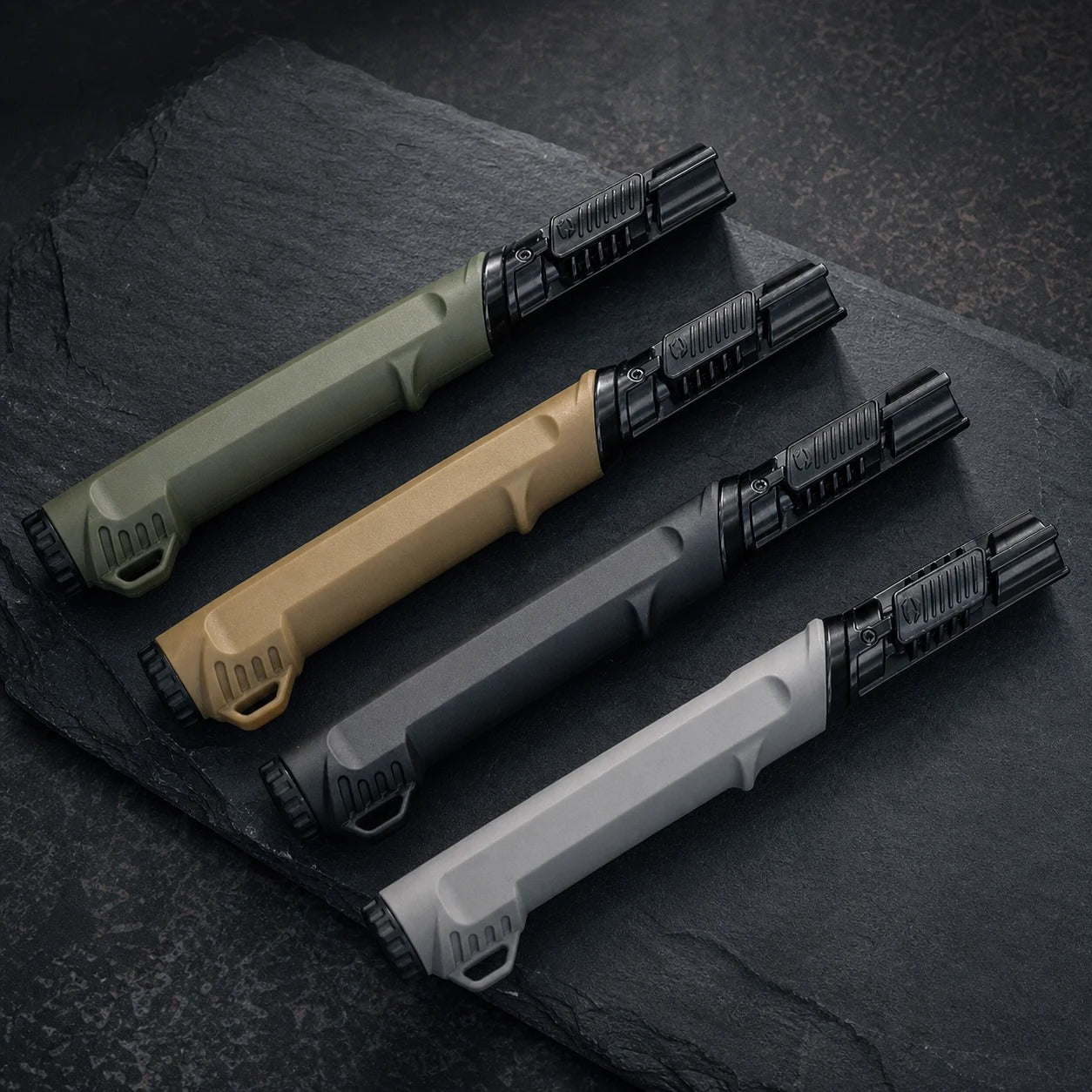 Outdoor ignition tools on a dark charcoal outdoor gear surface