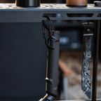 Black outdoor ignition tool attached to an outdoor gear setup